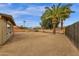 Large desert landscaped backyard with block wall offering privacy; tall palms add to the appeal at 915 S Saranac Ave, Mesa, AZ 85208