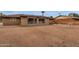 Spacious backyard featuring desert landscaping, patio seating, and large windows to the home's interior at 915 S Saranac Ave, Mesa, AZ 85208