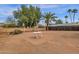 Spacious backyard featuring a desert landscape, mature trees and a patio with table at 915 S Saranac Ave, Mesa, AZ 85208