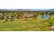 Scenic view of the golf course with a tranquil pond, lush greenery and distant mountain views at 915 S Saranac Ave, Mesa, AZ 85208