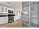 Spacious kitchen featuring stainless steel appliances, sleek white cabinets, and ample counter space at 915 S Saranac Ave, Mesa, AZ 85208