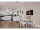 Bright kitchen featuring white cabinets, black countertops, and a cozy dining area at 915 S Saranac Ave, Mesa, AZ 85208