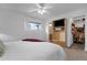 Spacious bedroom featuring a television, ceiling fan, and access to a walk-in closet at 915 S Saranac Ave, Mesa, AZ 85208