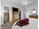 Large bedroom features a ceiling fan, television, and easy access to the ensuite bathroom at 915 S Saranac Ave, Mesa, AZ 85208