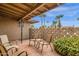 Enclosed patio with tile flooring, comfortable seating, and a decorative block wall at 915 S Saranac Ave, Mesa, AZ 85208