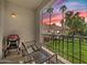 Cozy balcony with seating area, a grill, and a stunning view of the lush landscaping and colorful sunset at 9708 E Via Linda -- # 2328, Scottsdale, AZ 85258