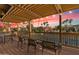 Enjoy the view of the tennis court from the covered balcony seating area with tables and chairs at 9708 E Via Linda -- # 2328, Scottsdale, AZ 85258
