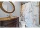 Charming bathroom featuring vanity with granite countertop, decorative mirror, and elegant marble-pattern shower curtain at 9708 E Via Linda -- # 2328, Scottsdale, AZ 85258
