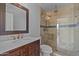 Elegant bathroom featuring a marble countertop, dark wood vanity, and glass-enclosed shower with tile surround at 9708 E Via Linda -- # 2328, Scottsdale, AZ 85258