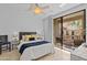 Sunlit bedroom features a sliding glass door to a private balcony and neutral decor at 9708 E Via Linda -- # 2328, Scottsdale, AZ 85258