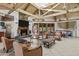 Bright clubhouse area with exposed beams, a fireplace, tv, and an adjacent kitchenette at 9708 E Via Linda -- # 2328, Scottsdale, AZ 85258