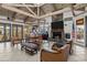 Bright clubhouse area with exposed beams, a fireplace, tv, and an adjacent kitchenette at 9708 E Via Linda -- # 2328, Scottsdale, AZ 85258