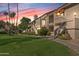 Picturesque condo buildings with lush landscaping, well-manicured lawn, and a vibrant sunset sky in the background at 9708 E Via Linda -- # 2328, Scottsdale, AZ 85258