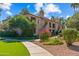 Well-maintained condo buildings with beautiful landscaping, including mature trees, colorful plants, and a paved walkway at 9708 E Via Linda -- # 2328, Scottsdale, AZ 85258