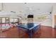 Spacious recreation room featuring a ping pong table, mirrored wall, and hardwood flooring at 9708 E Via Linda -- # 2328, Scottsdale, AZ 85258
