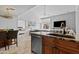Open kitchen showcasing stainless steel appliances, granite countertops, and connection to living area at 9708 E Via Linda -- # 2328, Scottsdale, AZ 85258