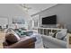 Comfortable living area featuring a large screen TV, stylish furniture, and bright, neutral tones at 9708 E Via Linda -- # 2328, Scottsdale, AZ 85258