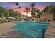 Community swimming pool with lounge chairs and lush trees around the deck at 9708 E Via Linda -- # 2328, Scottsdale, AZ 85258
