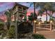 Inviting entrance to The Racquet Club featuring a bridge, well-maintained landscaping, and a welcoming sign at 9708 E Via Linda -- # 2328, Scottsdale, AZ 85258
