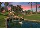 Beautiful water feature with a small waterfall, pond, and swan, surrounded by lush landscaping and trees at 9708 E Via Linda -- # 2328, Scottsdale, AZ 85258