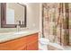 Well-lit bathroom featuring a granite vanity countertop and shower with patterned curtain; functional and stylish at 10136 E Southern Ave # 1082, Mesa, AZ 85209