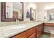 Bathroom with double sinks, granite countertops, wood cabinets and framed mirrors at 10136 E Southern Ave # 1082, Mesa, AZ 85209