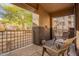 Relaxing patio area with chairs and greenery, creating a cozy outdoor living space in the building complex at 10136 E Southern Ave # 1082, Mesa, AZ 85209