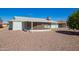 An exterior view of the back of this home reveals the enclosed patio and low-maintenance landscaping at 10319 W Twin Oaks Dr, Sun City, AZ 85351