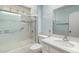 Bathroom features shower-tub with glass doors, white cabinets and counters at 10319 W Twin Oaks Dr, Sun City, AZ 85351