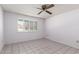 Bedroom featuring window with plantation shutters and tile flooring at 10319 W Twin Oaks Dr, Sun City, AZ 85351