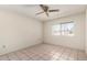 This bedroom features a ceiling fan, neutral walls and floors, and a window at 10319 W Twin Oaks Dr, Sun City, AZ 85351