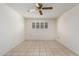 A bedroom featuring neutral walls, tile floors, and a window with blinds at 10319 W Twin Oaks Dr, Sun City, AZ 85351