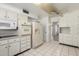 Bright kitchen with white cabinets, tile flooring, and vintage appliances at 10319 W Twin Oaks Dr, Sun City, AZ 85351