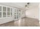 Living room featuring tiled floors and large windows with plantation shutters at 10319 W Twin Oaks Dr, Sun City, AZ 85351