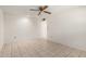 A living room featuring neutral walls, tile floors, and a ceiling fan at 10319 W Twin Oaks Dr, Sun City, AZ 85351