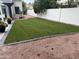 Wide view of backyard showing sod, decorative landscaping, and exterior of the property at 10360 N 98Th St, Scottsdale, AZ 85258