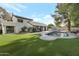 A beautiful backyard with a pool, green grass, and a pergola at 10360 N 98Th St, Scottsdale, AZ 85258