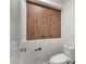 Bathroom featuring a modern toilet and stylish storage with wood finish doors at 10360 N 98Th St, Scottsdale, AZ 85258