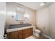 Modern powder room featuring a gray vessel sink and stylish wood cabinetry at 10360 N 98Th St, Scottsdale, AZ 85258