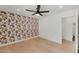 Bedroom featuring an accent wall with wallpaper and light wood flooring at 10360 N 98Th St, Scottsdale, AZ 85258