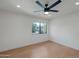 Bedroom featuring a ceiling fan and large window with neighborhood views at 10360 N 98Th St, Scottsdale, AZ 85258