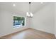 Clean dining room with hardwood floors and a window overlooking the backyard swimming pool at 10360 N 98Th St, Scottsdale, AZ 85258