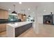 Gourmet kitchen open to the living area, featuring a center island, fireplace and modern appliances at 10360 N 98Th St, Scottsdale, AZ 85258