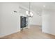 Bright living room showcasing a sleek chandelier and doorway to a temperature controlled wine cellar at 10360 N 98Th St, Scottsdale, AZ 85258