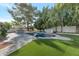 A serene pool area featuring lush landscaping and an outdoor grill at 10360 N 98Th St, Scottsdale, AZ 85258