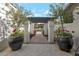 A welcoming walkway with trees in pots at the entrance at 10360 N 98Th St, Scottsdale, AZ 85258