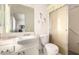 Bathroom featuring a sink, toilet, and shower with grab bars at 10809 W El Dorado Dr, Sun City, AZ 85351