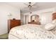 Comfortable bedroom with ceiling fan, wood furniture, and floral accents at 10809 W El Dorado Dr, Sun City, AZ 85351