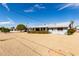 Charming single-story home with a well-manicured yard and a covered patio, perfect for outdoor entertaining at 10809 W El Dorado Dr, Sun City, AZ 85351