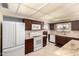 Kitchen featuring granite countertops, stainless steel appliances, and warm wooden cabinetry at 10809 W El Dorado Dr, Sun City, AZ 85351